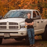 A Fall portrait of a senior guy standing next to his truck in Central Wisconsin, near Wausau.